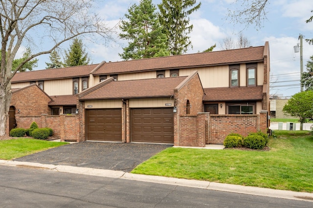 view of property featuring a shingled roof, aphalt driveway, brick siding, and a garage