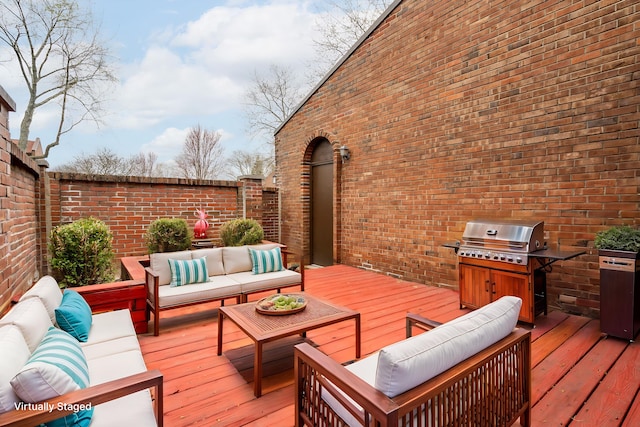 deck featuring grilling area, fence, exterior kitchen, and an outdoor hangout area