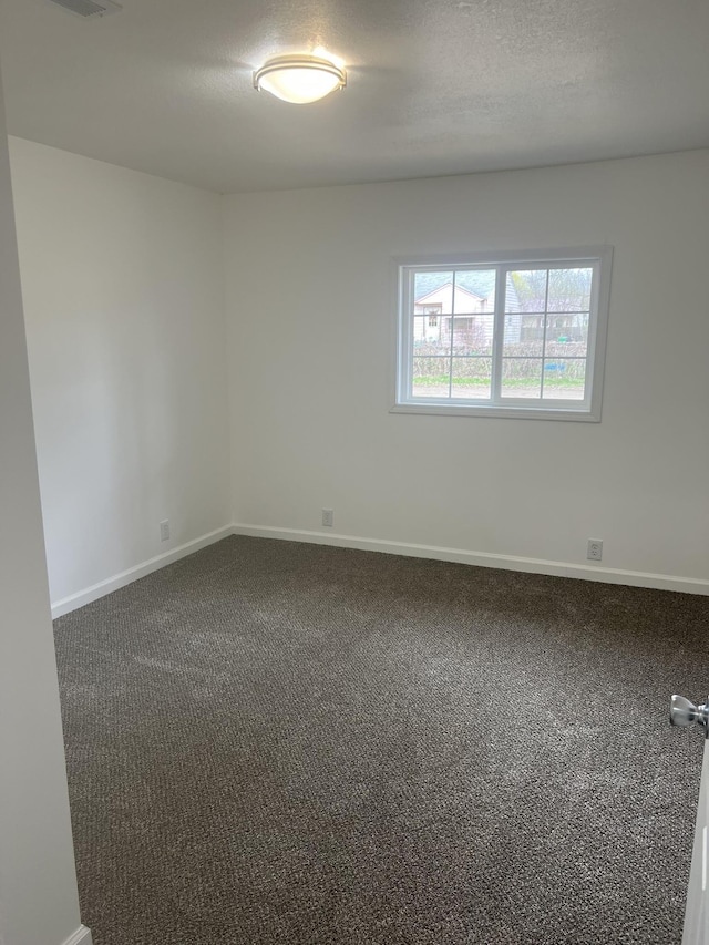 1314 Alexandrine St, Mount Morris, MI 48458 - empty room featuring dark colored carpet and baseboards