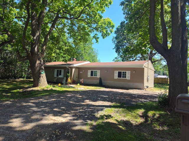 1314 Alexandrine St, Mount Morris, MI 48458 - view of front of home featuring dirt driveway and a chimney
