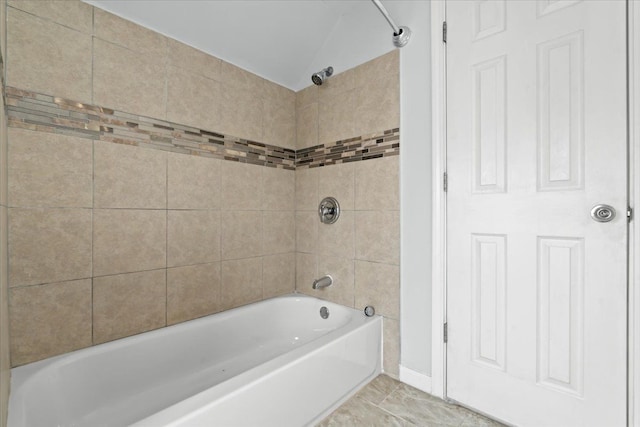 bathroom with shower / bathtub combination and baseboards