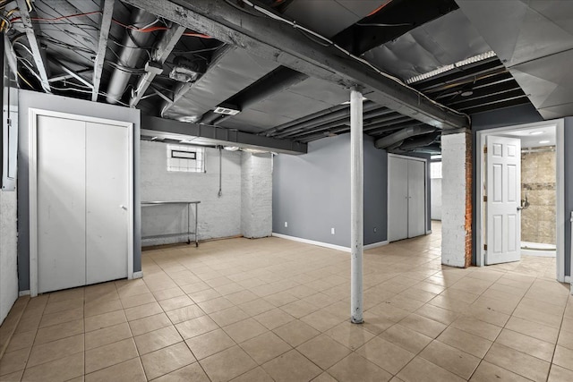 basement featuring tile patterned floors and plenty of natural light