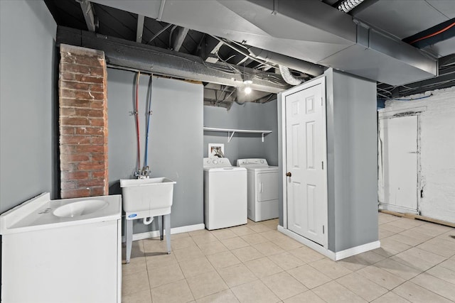 laundry area with separate washer and dryer, laundry area, baseboards, and light tile patterned floors