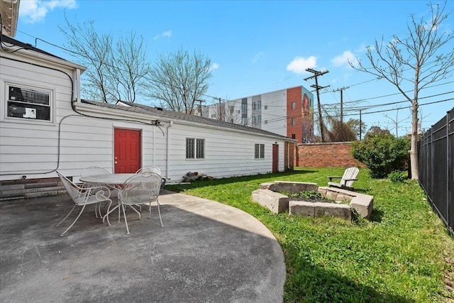 rear view of property featuring a fenced backyard, a patio area, a yard, and outdoor dining space