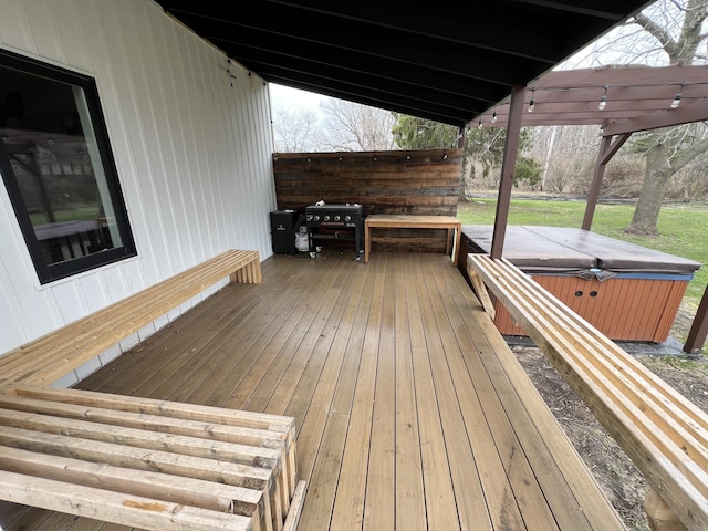 wooden terrace featuring a hot tub