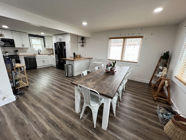 dining space featuring baseboards, recessed lighting, and dark wood finished floors