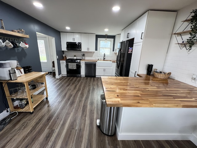 kitchen featuring a sink, stainless steel microwave, gas stove, dishwashing machine, and freestanding refrigerator