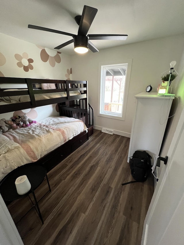 bedroom featuring baseboards, a ceiling fan, visible vents, and dark wood finished floors