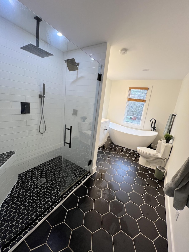bathroom featuring a freestanding bath, tile patterned floors, and a stall shower