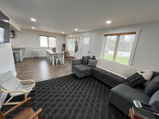 living room with recessed lighting, baseboards, and dark wood-style flooring