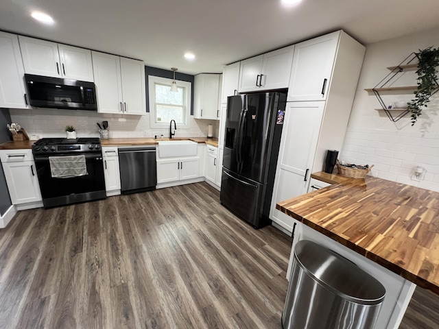kitchen with a sink, wooden counters, gas range, black fridge, and dishwashing machine