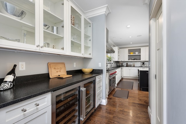 bar featuring decorative backsplash, wine cooler, range with two ovens, ornamental molding, and dark wood finished floors