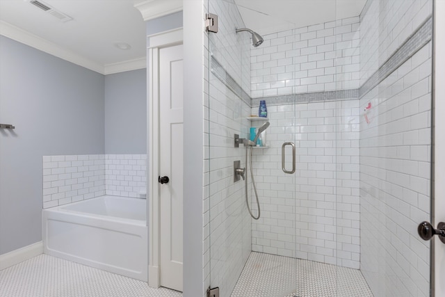 bathroom with ornamental molding, a bath, baseboards, visible vents, and a stall shower
