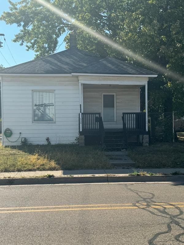 bungalow-style home with a porch and a shingled roof