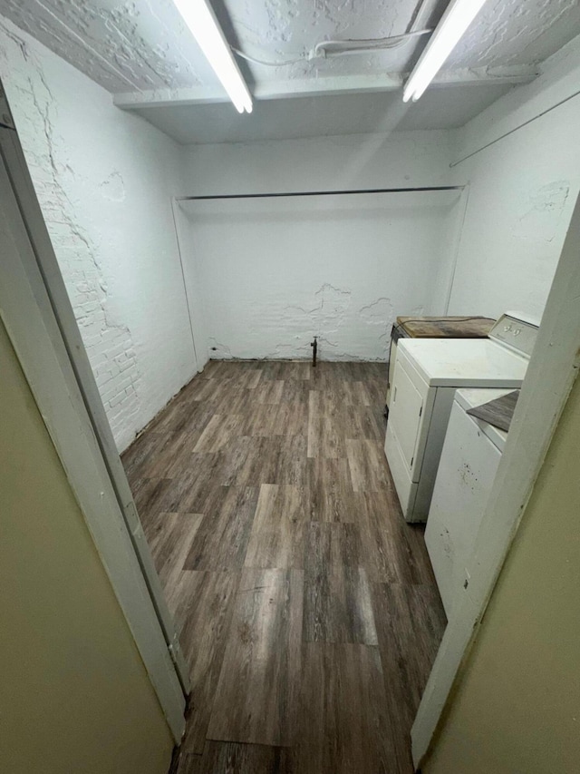 laundry room featuring wood finished floors, washing machine and clothes dryer, and laundry area