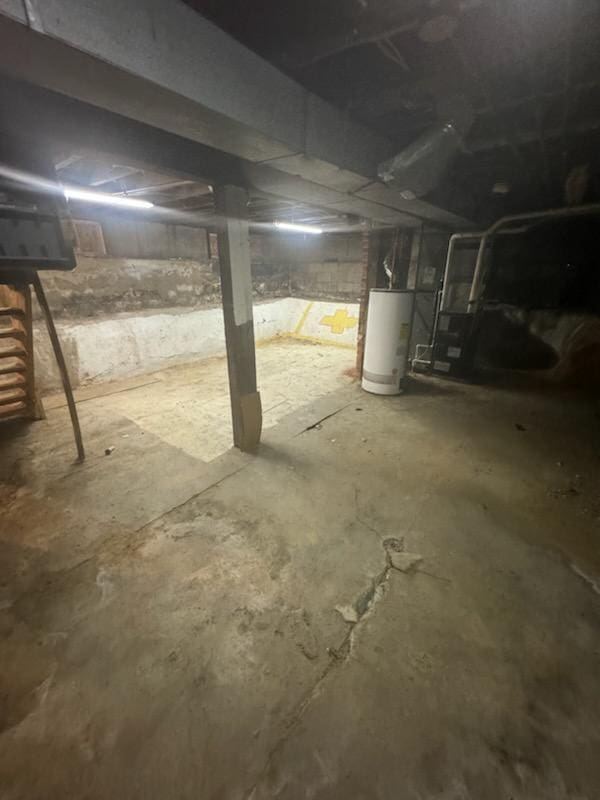 unfinished basement featuring water heater