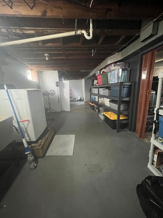 unfinished below grade area featuring washer / dryer