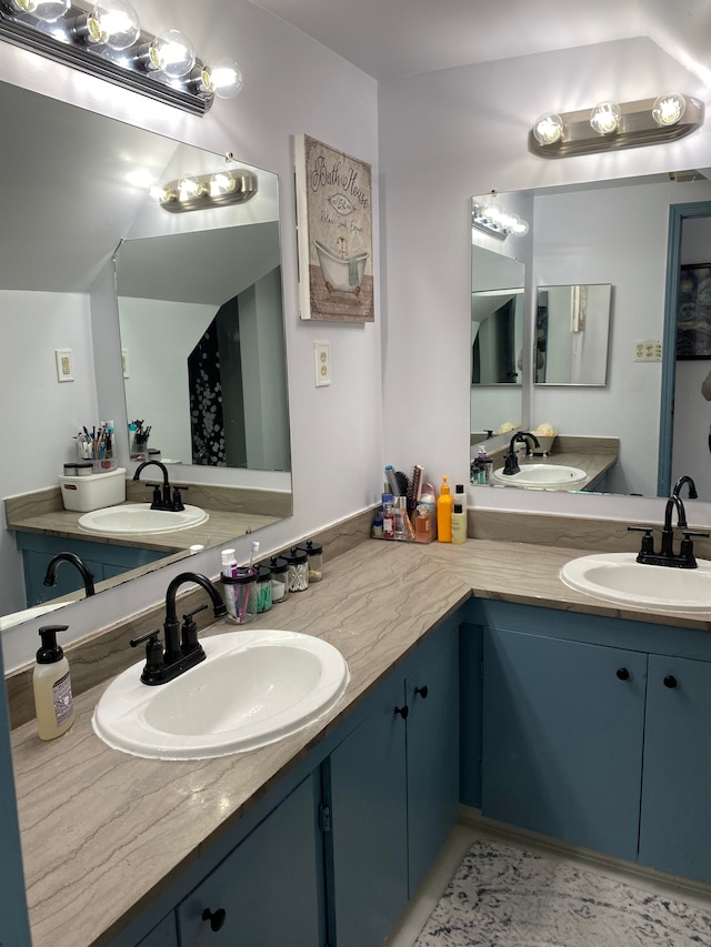 bathroom with two vanities and a sink
