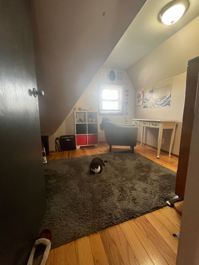 bonus room with vaulted ceiling and wood finished floors