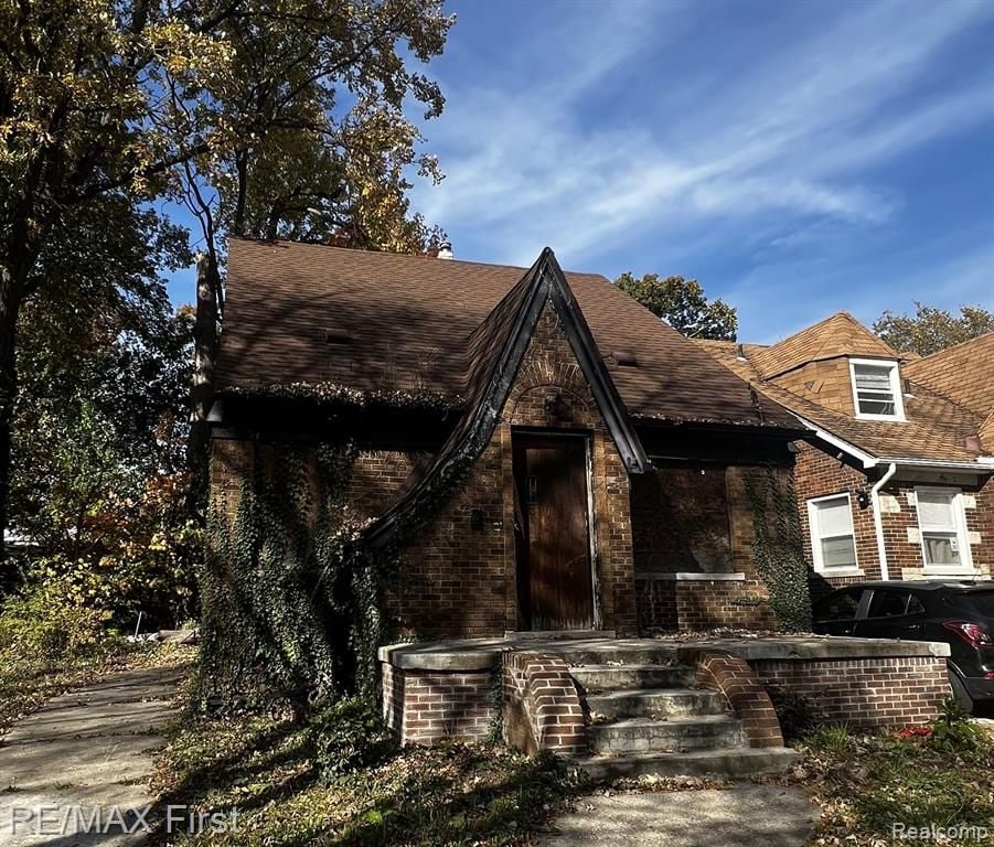 15857 Evanston St, Detroit, MI 48224 - view of front facade featuring brick siding and roof with shingles