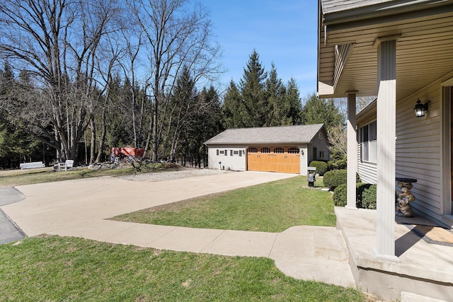 view of property exterior with a lawn, an outbuilding, and a detached garage