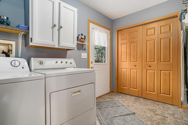 laundry area featuring washing machine and dryer and cabinet space