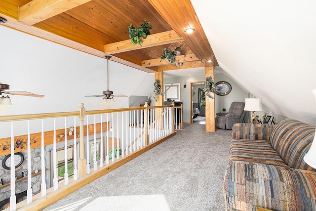 carpeted living area with lofted ceiling with beams, wood ceiling, and ceiling fan