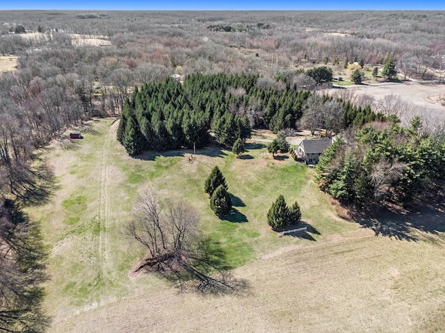 bird's eye view with a wooded view