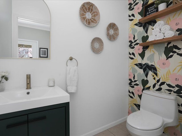 bathroom with vanity, baseboards, tile patterned floors, and toilet
