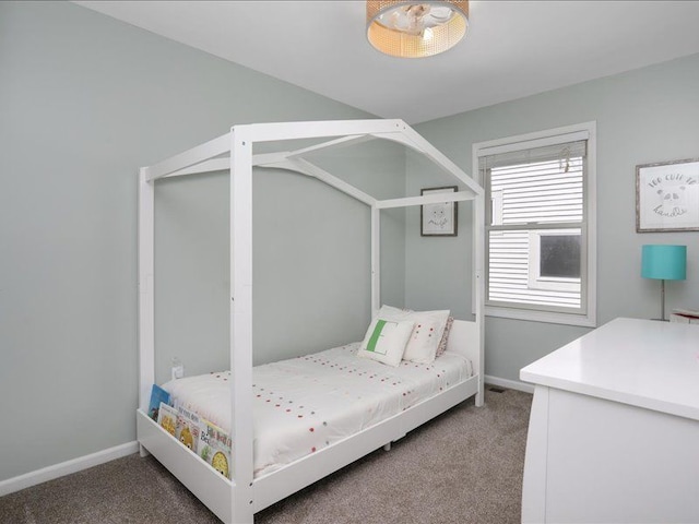 bedroom featuring baseboards and carpet flooring