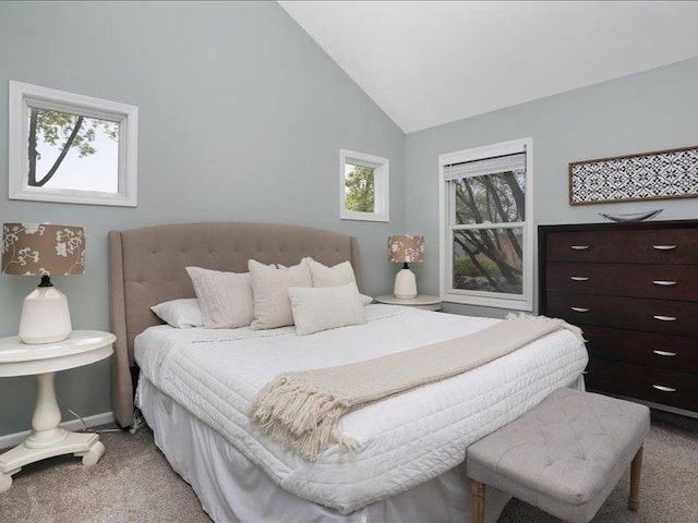 bedroom with light colored carpet, baseboards, high vaulted ceiling, and multiple windows
