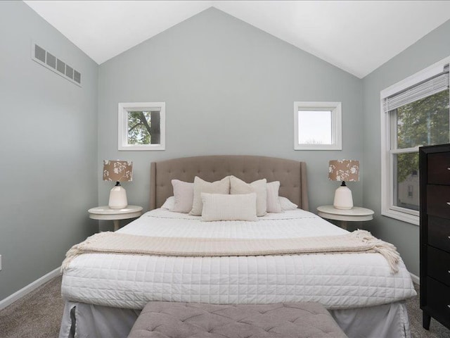 bedroom with visible vents, carpet floors, lofted ceiling, and multiple windows