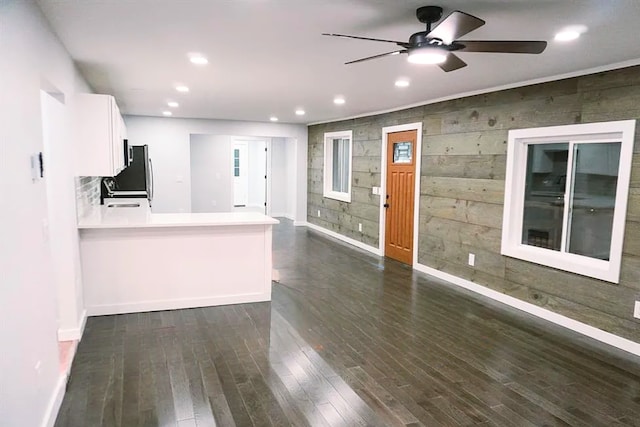 unfurnished living room featuring recessed lighting, a ceiling fan, a sink, dark wood-type flooring, and baseboards