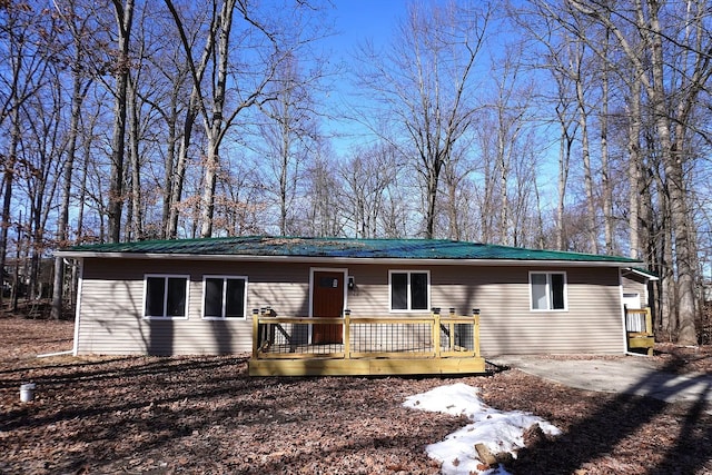 view of front facade with a deck and metal roof