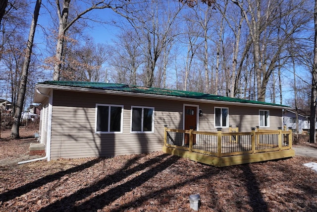 ranch-style house with a deck and metal roof