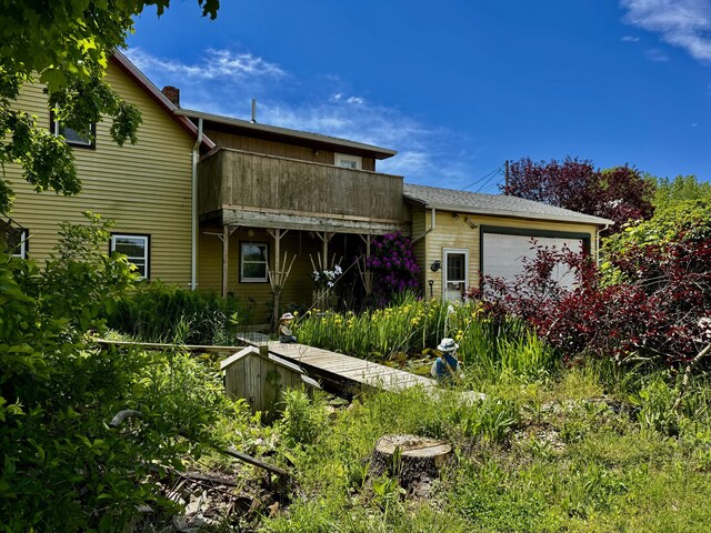 5670 S Niles Rd, Saint Joseph, MI 49085 - back of house with a garage and a chimney