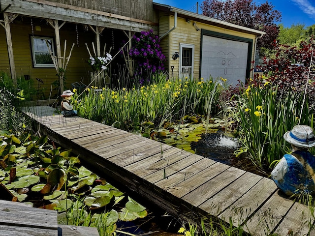 5670 S Niles Rd, Saint Joseph, MI 49085 - exterior space featuring a garage and a small pond