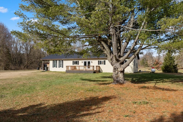 view of front of home featuring a deck and a front yard