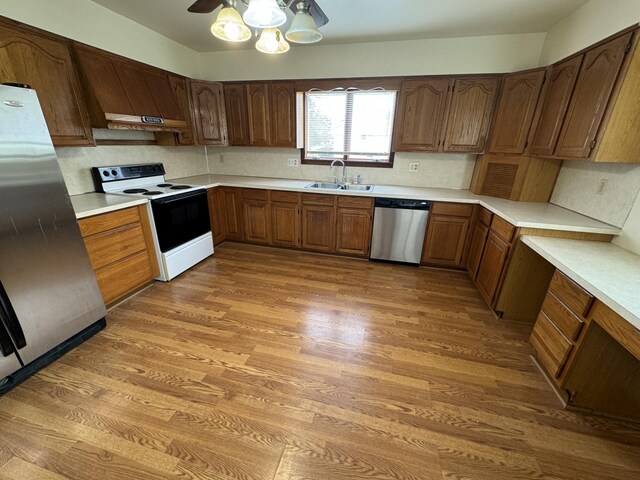 8066 Talladay Rd, Whittaker, MI 48190 - kitchen with light wood-type flooring, light countertops, a sink, and appliances with stainless steel finishes