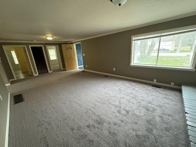 8066 Talladay Rd, Whittaker, MI 48190 - unfurnished living room featuring plenty of natural light, visible vents, carpet flooring, and crown molding