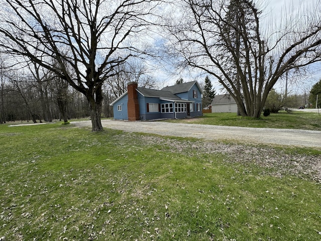 8066 Talladay Rd, Whittaker, MI 48190 - view of side of home featuring a chimney and a yard