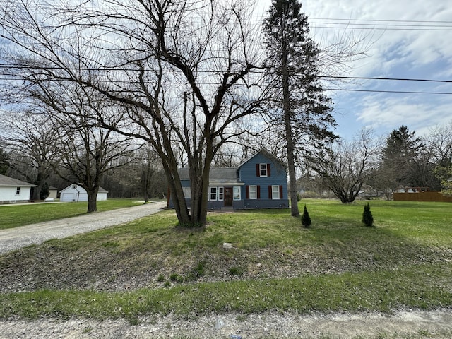 8066 Talladay Rd, Whittaker, MI 48190 - colonial inspired home with a front lawn and gravel driveway