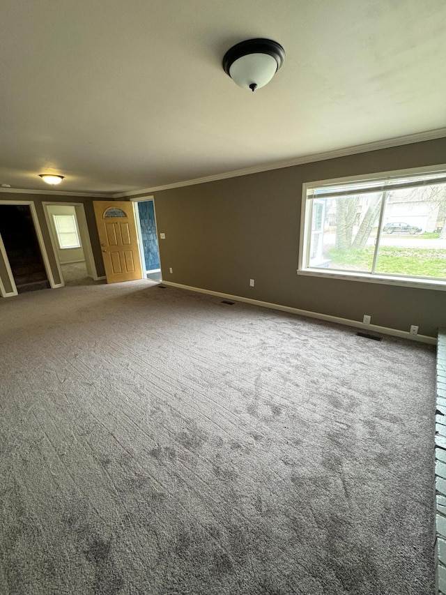 8066 Talladay Rd, Whittaker, MI 48190 - empty room featuring plenty of natural light, baseboards, carpet flooring, and crown molding