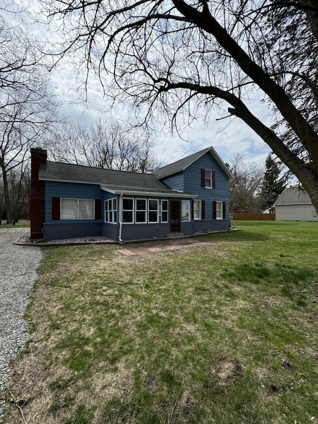 8066 Talladay Rd, Whittaker, MI 48190 - tri-level home featuring a chimney, roof with shingles, and a front yard