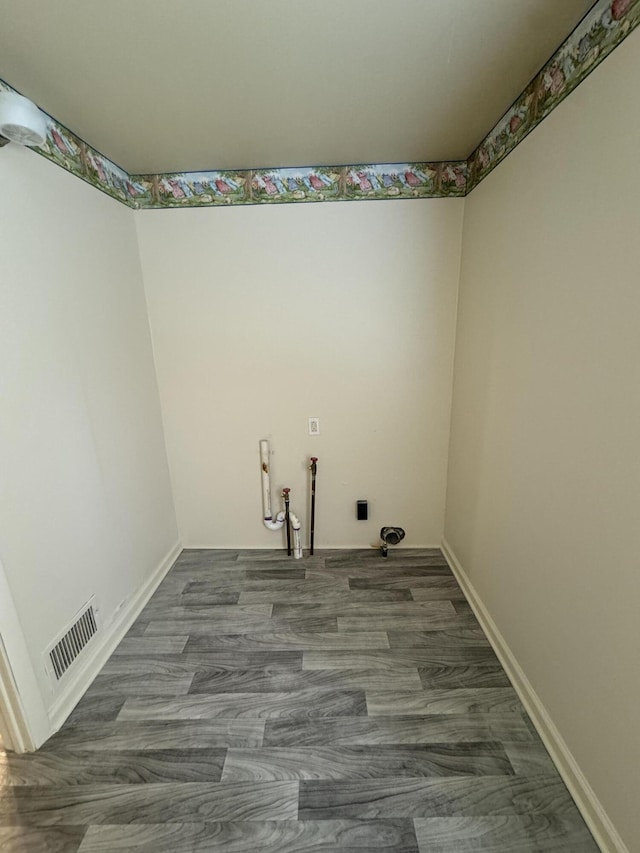 8066 Talladay Rd, Whittaker, MI 48190 - clothes washing area featuring baseboards, wood finished floors, visible vents, and laundry area