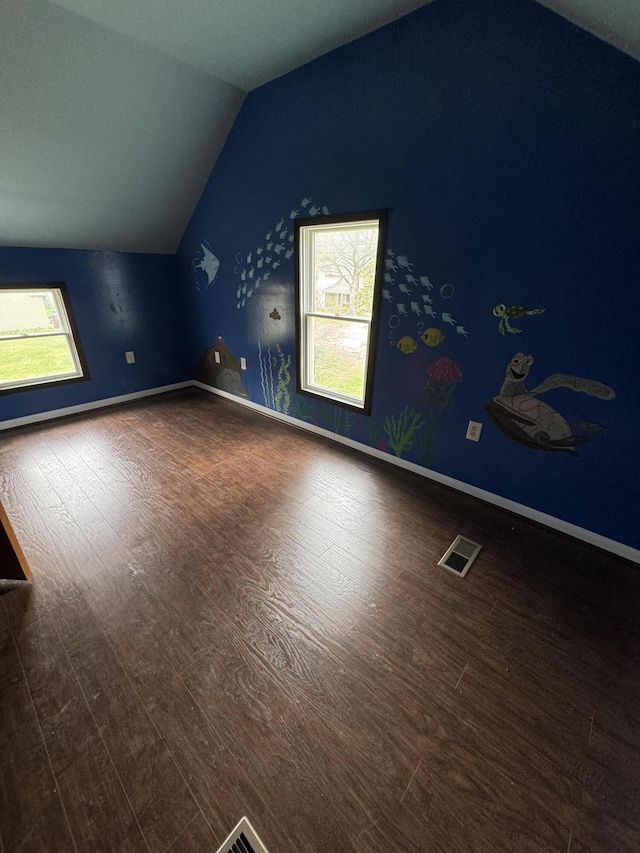 8066 Talladay Rd, Whittaker, MI 48190 - additional living space with lofted ceiling, baseboards, visible vents, and dark wood-style floors