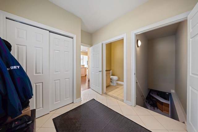 interior space with toilet, tile patterned floors, and baseboards