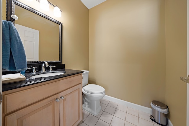 bathroom with tile patterned floors, vanity, toilet, and baseboards