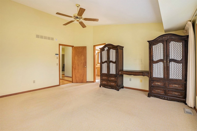 interior space featuring baseboards, visible vents, carpet, and ceiling fan