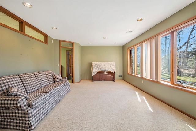 carpeted living area with recessed lighting, visible vents, and baseboards